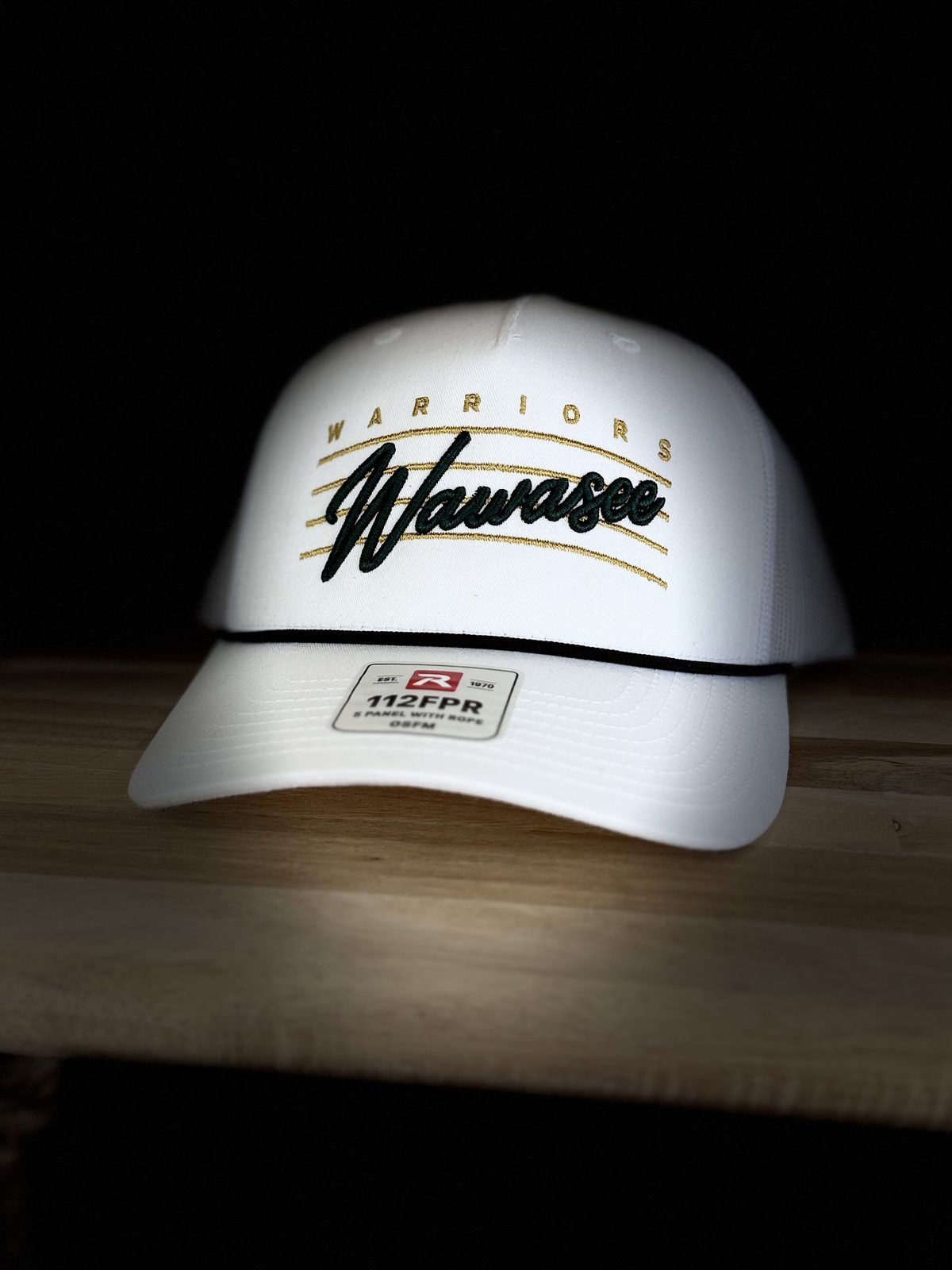 White rope-brim trucker cap with a raised green script Wawasee and gold underlines